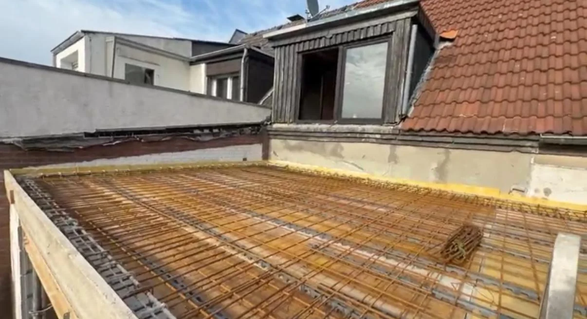 Slab reinforcement for an extension to an existing building